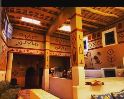 a room with graffiti on the walls of a building at Riad DAR outebba in Zaouïet Sidi Daoud