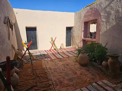 a courtyard of a building with vases on the ground at LA PETITE MAISON DU LAC IRIKI in Foum Zguid