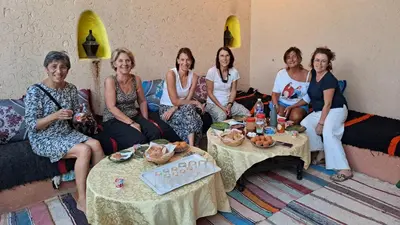 a group of women sitting in a room at LA PETITE MAISON DU LAC IRIKI in Foum Zguid