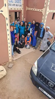 a group of people standing in front of a building at LA PETITE MAISON DU LAC IRIKI in Foum Zguid