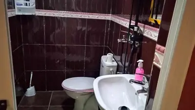 a small bathroom with a toilet and a sink at Auberge Cascade Imilchil in Imilchil