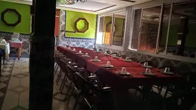a long table with chairs in a room at Auberge Cascade Imilchil in Imilchil