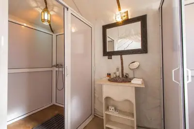 a bathroom with a mirror and a sink and a shower at Stargazing Merzouga Camp in Merzouga