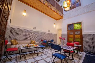 a living room with a couch and tables and chairs at Riad Fes Elite in Fès