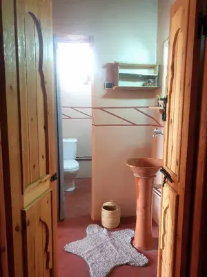 a bathroom with a toilet and a sink at Maison d'hôtes IZZA in Kalaat MGouna