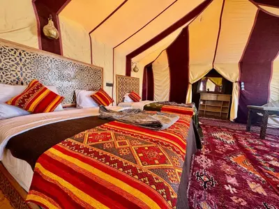 a bedroom with two beds in a tent at Dream luxury camp in Merzouga