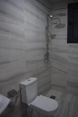 a white bathroom with a toilet and a sink at Moonrise Villa VIP Midelt in Midelt