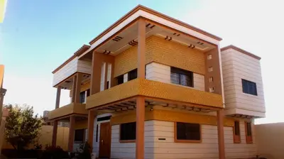 a tall building with yellow and white at Moonrise Villa VIP Midelt in Midelt