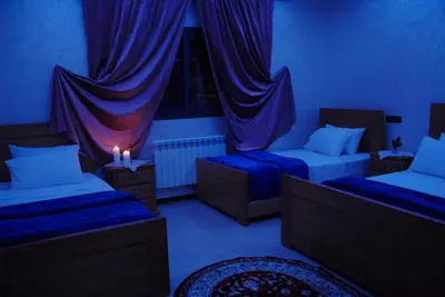 a blue room with two beds and two candles at Moonrise Villa VIP Midelt in Midelt