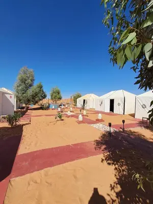 a courtyard with tents in the middle of a field at Royal Dune Private Tent in Merzouga