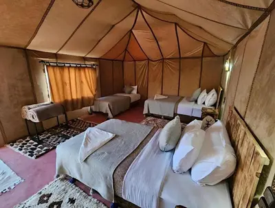 a bedroom with two beds in a tent at Sunshine luxury tent in Merzouga
