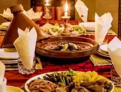 a table with plates of food on a table at Sunshine luxury tent in Merzouga
