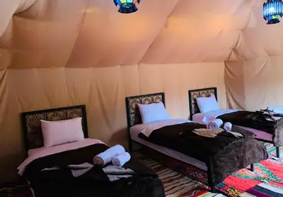 a room with two beds in a tent at Sunshine luxury tent in Merzouga