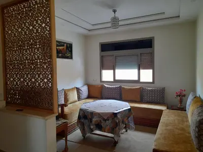 a living room with a couch and a table at Appartement meublé ennasr49 in Khenifra