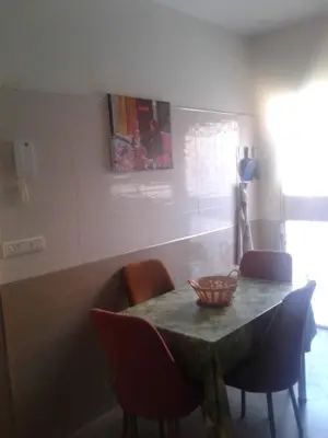 a dining room table with chairs and a bowl on it at Appartement meublé ennasr49 in Khenifra
