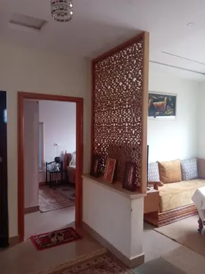 a living room with a couch and a mirror at Appartement meublé ennasr49 in Khenifra