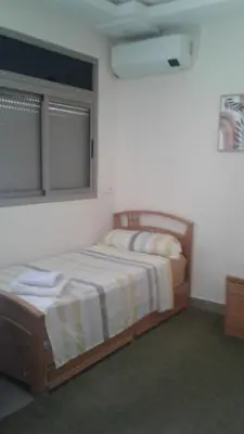 a bedroom with two beds and a window at Appartement meublé ennasr49 in Khenifra