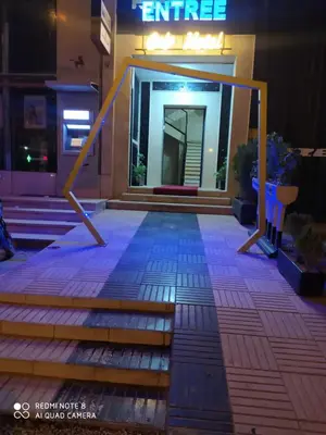 a front entrance of a building at night at Hotel La coline in Beni Mellal