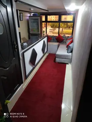 a hallway with a red carpet and a couch at Hotel La coline in Beni Mellal