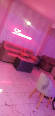 a living room with a couch and pink lights at Hotel La coline in Beni Mellal