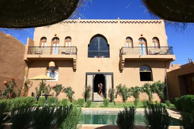a house with a pool in front of it at Riad Dar Tiziri in Zagora