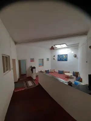 an empty room with a couch and a table in it at Dar Sahara Ouarzazate in Ouarzazate
