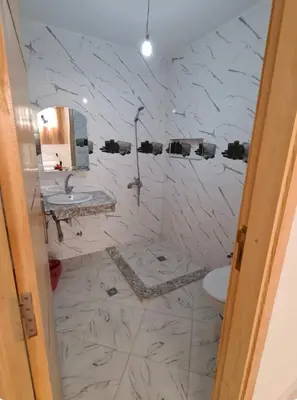 a bathroom with a toilet and a sink and a mirror at Appartement 2 chambres avec lit bébé in Fès
