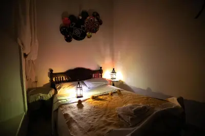 a bedroom with a bed with two lights on it at Riad bel kaid fes in Fès