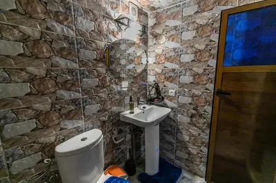 a stone bathroom with a sink and a toilet at Riad bel kaid fes in Fès