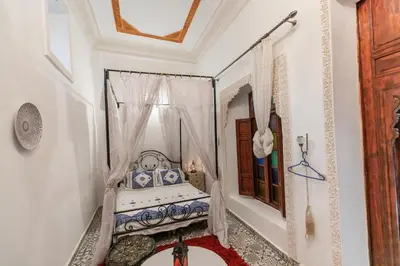 a bedroom with a bed with a canopy at Riad bel kaid fes in Fès