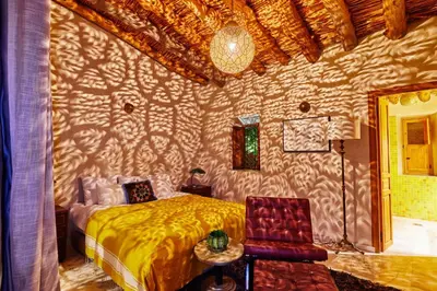a bedroom with a bed and a wall at Dar Imiri in Ourika