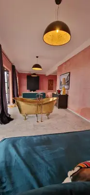 a large room with a tub in the middle of a room at Dar Imiri in Ourika