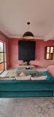 a room with a large bed with a large screen at Dar Imiri in Ourika