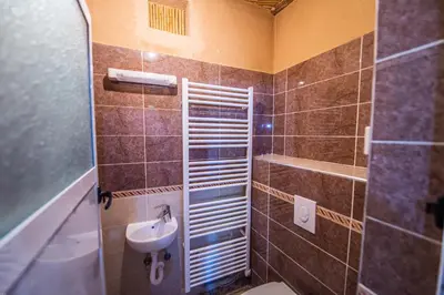 a small bathroom with a sink and a toilet at Riad Lalla in Tinerhir
