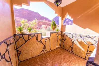 a balcony with a view of the mountains at Riad Lalla in Tinerhir