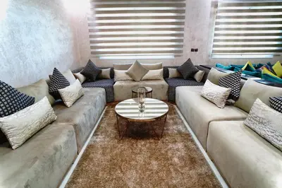 a living room with couches and a coffee table at Appartement Emeraude - Calme, Moderne & Sécurisé in Fès