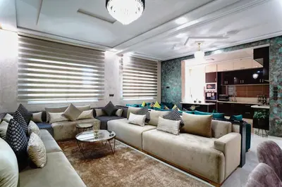 a living room with a couch and a table at Appartement Emeraude - Calme, Moderne & Sécurisé in Fès
