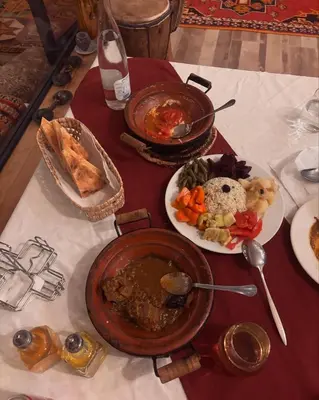 a table with plates of food on a table at Dar Nomad Tagounite in Zagora