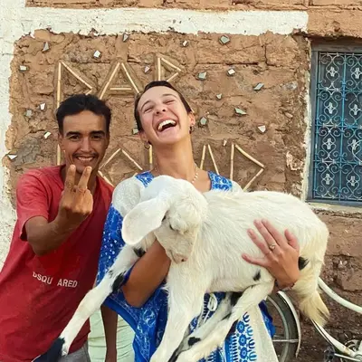a man and a woman holding a sheep at Dar Nomad Tagounite in Zagora