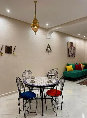 a dining room with a table and chairs and a couch at Stay In Fez in Fès