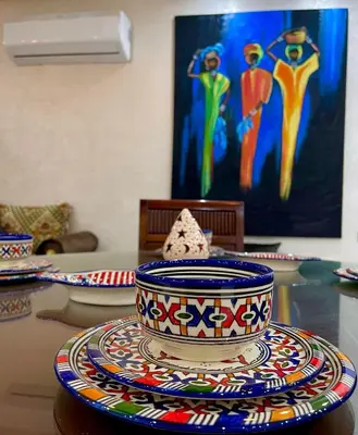 a table topped with colorful bowls and plates on a table at Stay In Fez in Fès