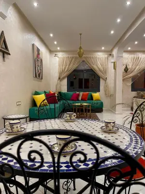 a living room with a table and a couch at Stay In Fez in Fès