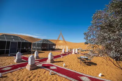 a desert with a sign that says morocco in the background at Mouhou Desert Camp in Merzouga