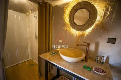 a bathroom with a bowl sink on a counter at Mouhou Desert Camp in Merzouga