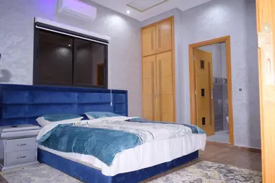 a bedroom with a blue bed and a window at Villa world Marrakech in Marrakech