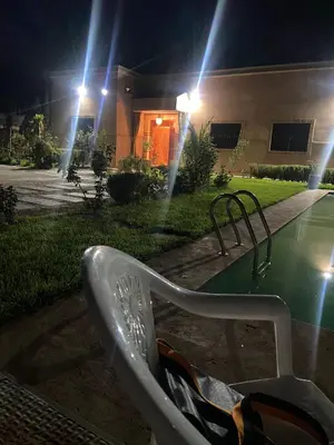 a white bench in front of a house at night at Villa world Marrakech in Marrakech