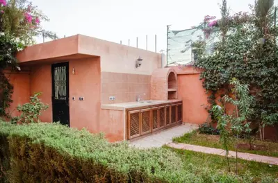 a small house with a sink in a yard at Villa world Marrakech in Marrakech