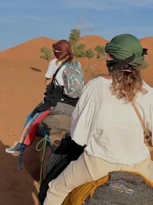 two people riding a horse in the desert at Bivouac beauté du désert in Mhamid