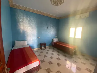 a bedroom with a bed and a window in a room at Apartement Rachid in Merzouga