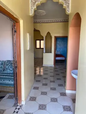 a hallway of a house with a tile floor at Apartement Rachid in Merzouga
